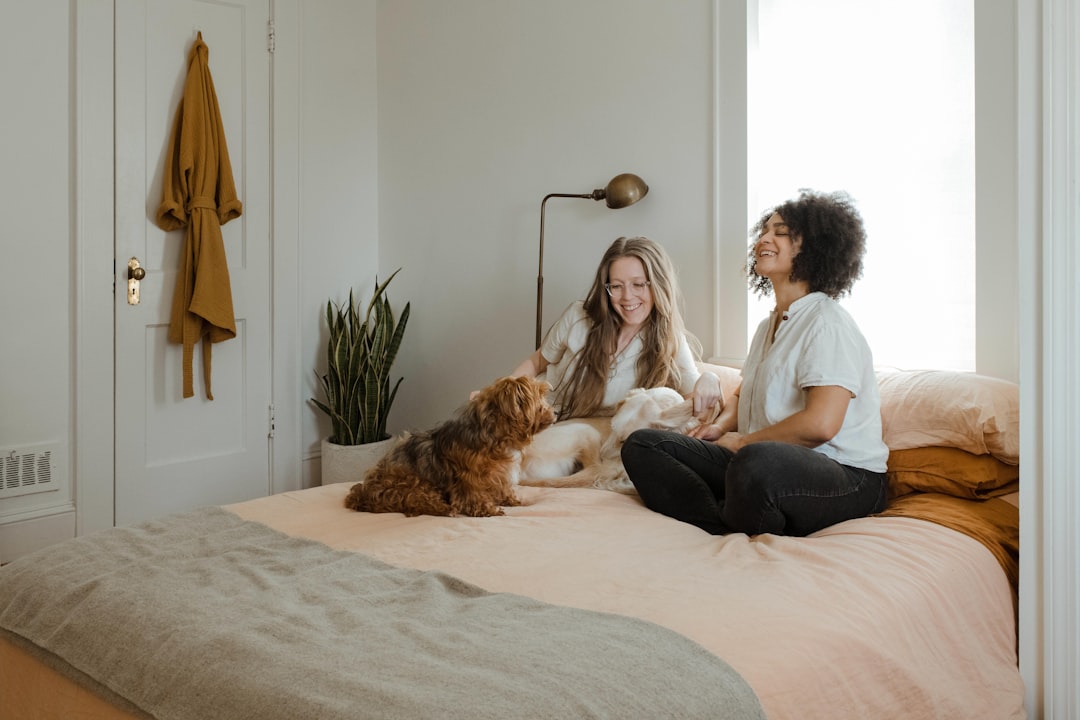 Pet companionship in a cozy home scene with a person and two pets by the window